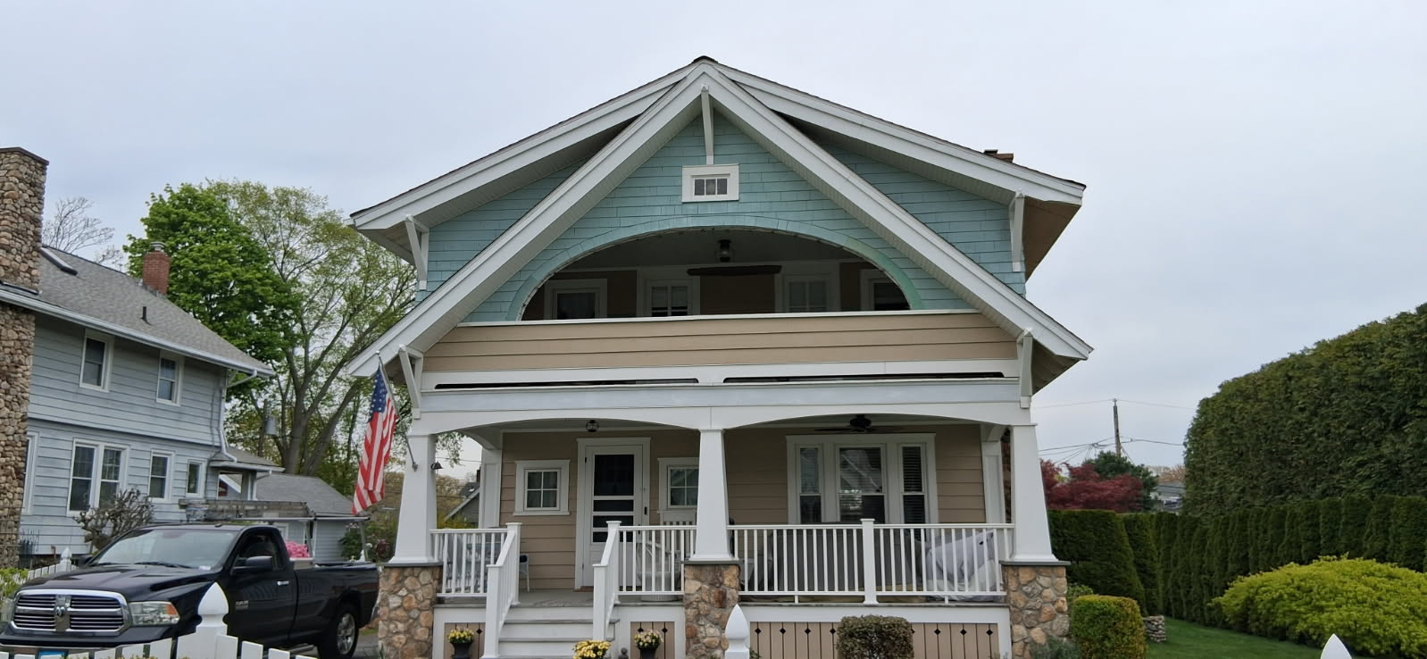 Coastal bungalow before repainting, with a weathered two-tone blue and tan exterior